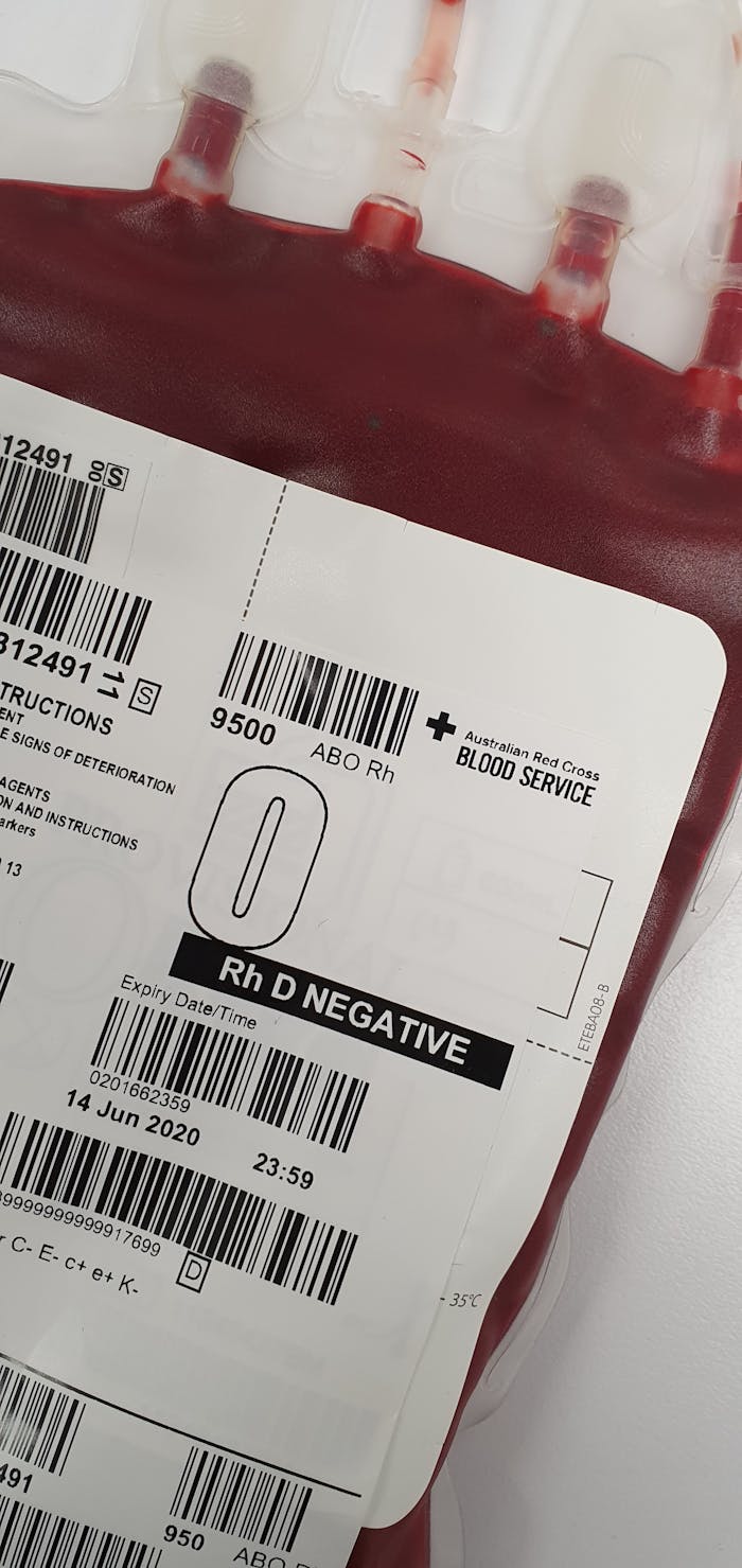 Detailed view of a blood bag labeled Rh D Negative for medical donation purposes.